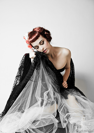 Portrait of a young woman with red hair in a black and white tutu