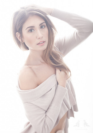 Portrait of a young woman with an ostomy bag and slouchy cardigan