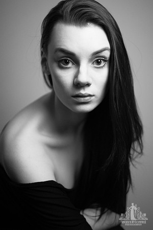 Black and white portrait of a young woman looking at the camera