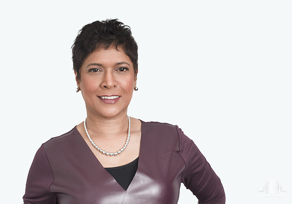 Studio headshot of an older woman smiling at the camera