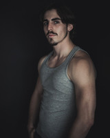 Portrait of a young man with a mustache looking at the camera