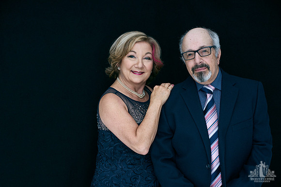 Contemporary studio portrait of an older couple smiling at the camera by Vancouver portrait photographer Angela McConnell