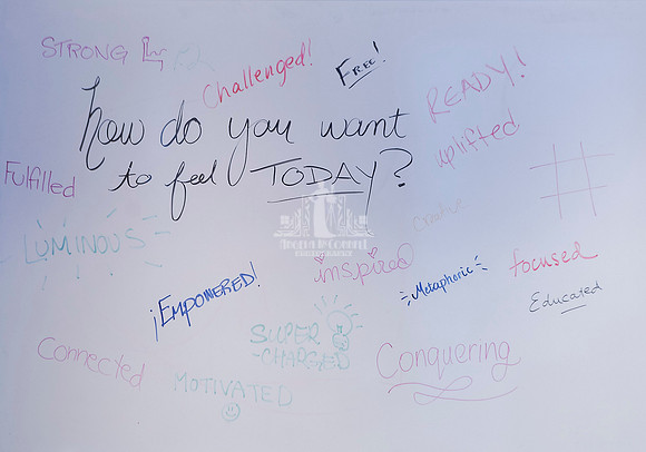 Words of empowerment written on a white board surrounding the words How do you want to feel today during a workshop