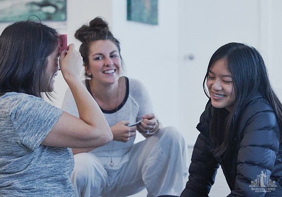A facilitator guides a mother and daughter during an exercise at a mother and daughter workshop by Vancouver workshop and retreat photographer Angela McConnell