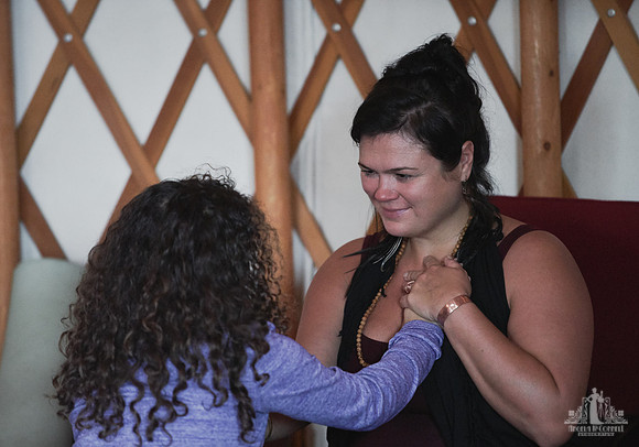 A mother listens and smiles as her daughter is speaking during an exercise at a mother and daughter workshop by Vancouver workshop and retreat photographer Angela McConnell