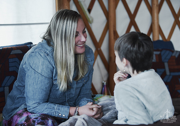 A mother listens and smiles as her daughter is speaking during an exercise at a mother and daughter workshop by Vancouver workshop and retreat photographer Angela McConnell