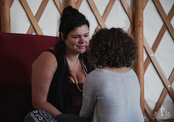 A mother listens and smiles as her daughter is speaking during an exercise at a mother and daughter workshop by Vancouver workshop and retreat photographer Angela McConnell