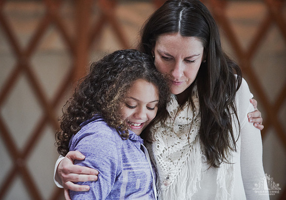 A facilitator hugs one of the attendees  at a mother and daughter workshop by Vancouver workshop and retreat photographer Angela McConnell