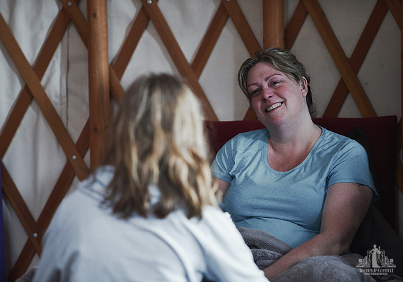 A mother listens and smiles as her daughter is speaking during an exercise at a mother and daughter workshop by Vancouver workshop and retreat photographer Angela McConnell