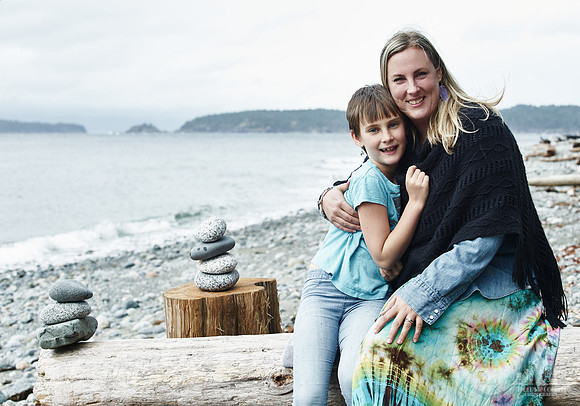 A mother and daughter hug during portraits on a beach  at a mother and daughter workshop by Vancouver workshop and retreat photographer Angela McConnell