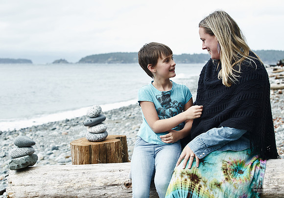 A mother and daughter hug during portraits on a beach  at a mother and daughter workshop by Vancouver workshop and retreat photographer Angela McConnell