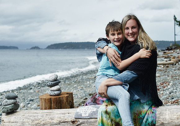 A mother and daughter hug during portraits on a beach  at a mother and daughter workshop by Vancouver workshop and retreat photographer Angela McConnell