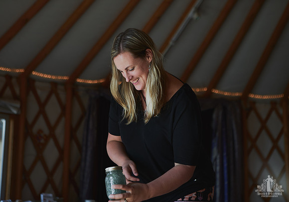 A mother smiles during an art project exercise at a mother and daughter workshop by Vancouver workshop and retreat photographer Angela McConnell