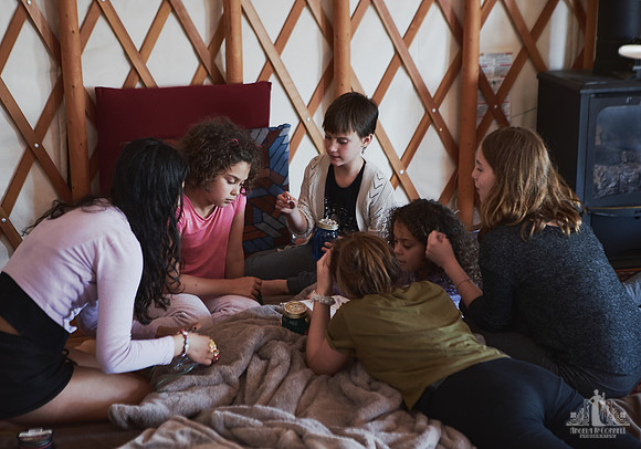 Girls work together on a project at a mother and daughter workshop by Vancouver workshop and retreat photographer Angela McConnell