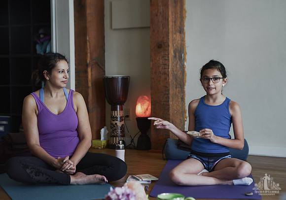 A mother and daughter sit together during an exercise at a mother and daughter workshop by Vancouver workshop and retreat photographer Angela McConnell