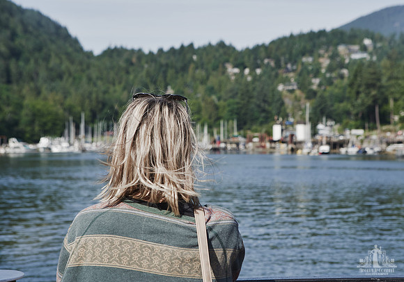 A women looks out from the ferry over to Bowen Island at a courage and bravery workshop by Vancouver workshop and retreat photographer Angela McConnell