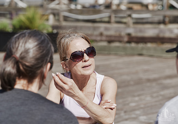 A woman speaks to a facilitator during an exercise at a courage and bravery workshop by Vancouver workshop and retreat photographer Angela McConnell