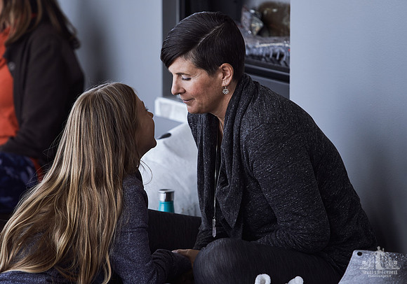 A mother listens and smiles as her daughter is speaking during an exercise at a mother and daughter workshop by Vancouver workshop and retreat photographer Angela McConnell