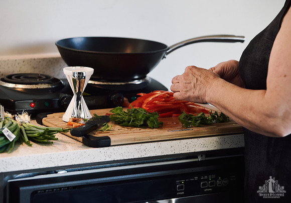 Fresh food is prepared on a chopping block at a womens' retreat at Halfmoon Haven on the Sunshine Coast, BC by Vancouver workshop and retreat photographer Angela McConnell