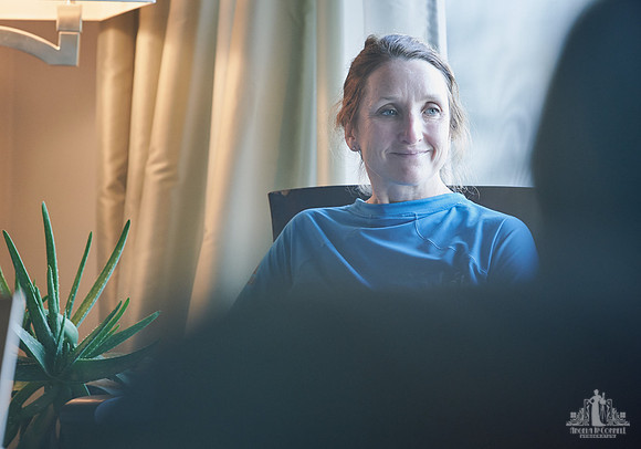 A woman smiles during a group exercise at a womens' retreat at Halfmoon Haven on the Sunshine Coast, BC by Vancouver workshop and retreat photographer Angela McConnell