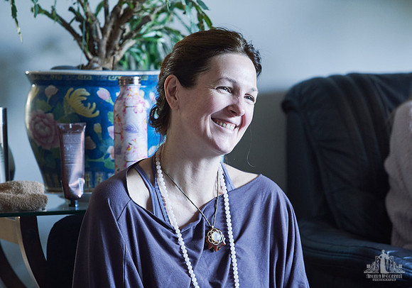 A woman smiles during a group exercise at a womens' retreat at Halfmoon Haven on the Sunshine Coast, BC by Vancouver workshop and retreat photographer Angela McConnell