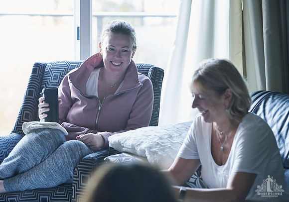 Two women laugh together during a group exercise  at a womens' retreat at Halfmoon Haven on the Sunshine Coast, BC by Vancouver workshop and retreat photographer Angela McConnell
