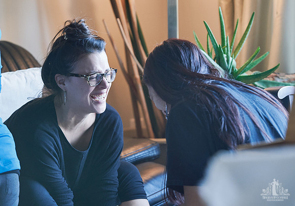 Two women laugh together during a group exercise  at a womens' retreat at Halfmoon Haven on the Sunshine Coast, BC by Vancouver workshop and retreat photographer Angela McConnell