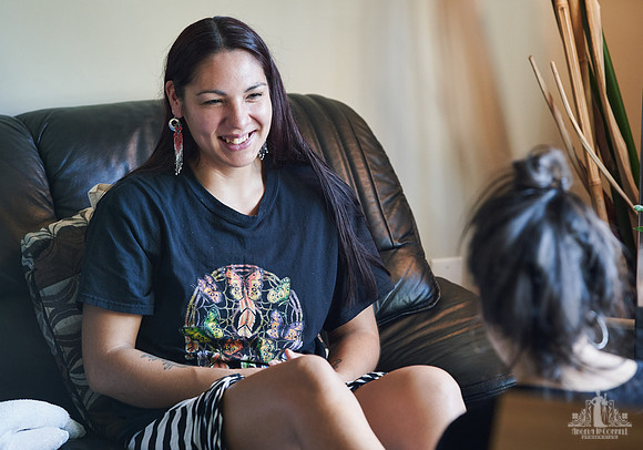 A woman smiles during a group exercise at a womens' retreat at Halfmoon Haven on the Sunshine Coast, BC by Vancouver workshop and retreat photographer Angela McConnell