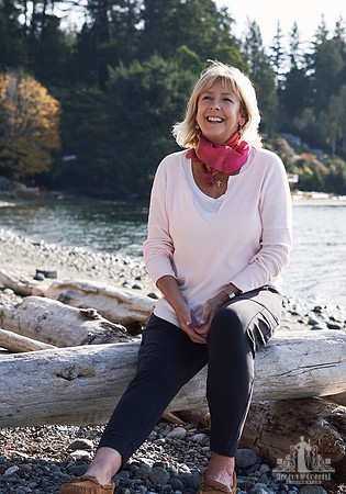 Portrait of a woman smiling on the beach at a womens' retreat at Halfmoon Haven on the Sunshine Coast, BC by Vancouver workshop and retreat photographer Angela McConnell