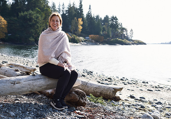 Portrait of a woman smiling on the beach at a womens' retreat at Halfmoon Haven on the Sunshine Coast, BC by Vancouver workshop and retreat photographer Angela McConnell