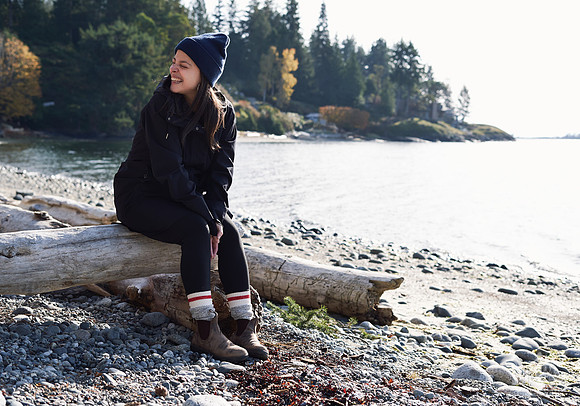 Portrait of a woman smiling on the beach at a womens' retreat at Halfmoon Haven on the Sunshine Coast, BC by Vancouver workshop and retreat photographer Angela McConnell