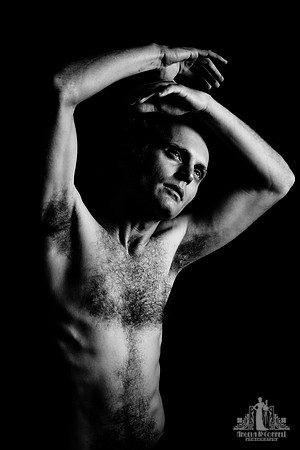 Black and white portrait of a shirtless man performing