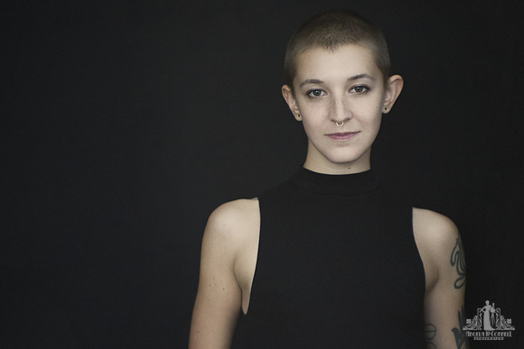 Natural Light portrait of a young woman with a shaved head and tattoos