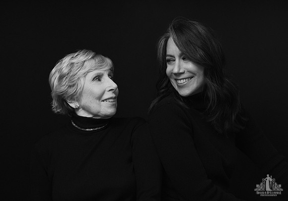 Contemporary black and white studio photo of a woman looking and smiling at her elderly mother by Vancouver portrait photographer Angela McConnell