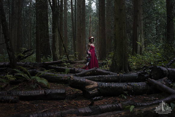 Contemporary natural light portrait of a young woman in a red dress and flower crown in the Pacific Spirit Park by Vancouver portrait photographer Angela McConnell