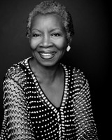 Black and white portrait of an older black woman smiling at the camera