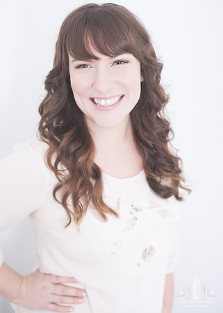 Portrait of a young woman with curly hair smiling at the camera
